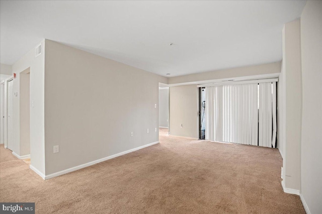 unfurnished room with light colored carpet