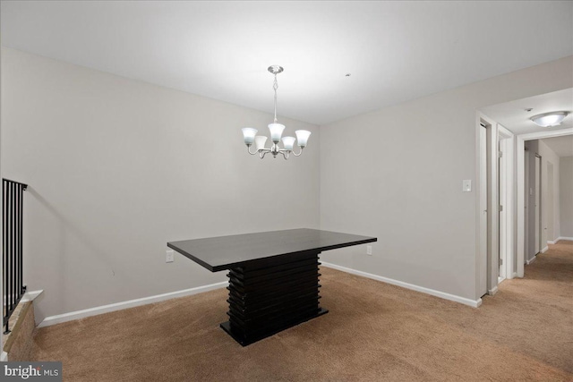 dining room with a chandelier and carpet floors