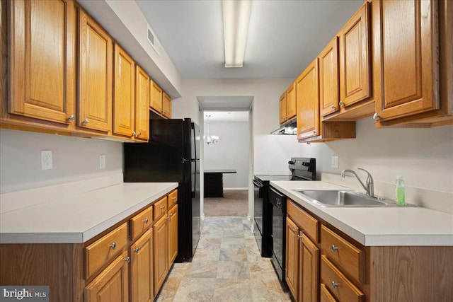 kitchen with black appliances, sink, and a notable chandelier