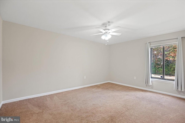 carpeted empty room featuring ceiling fan