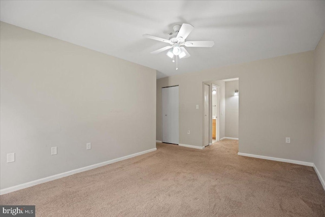 unfurnished room with light colored carpet and ceiling fan