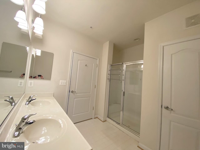 bathroom with vanity and a shower with shower door