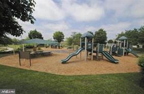 view of jungle gym featuring a lawn