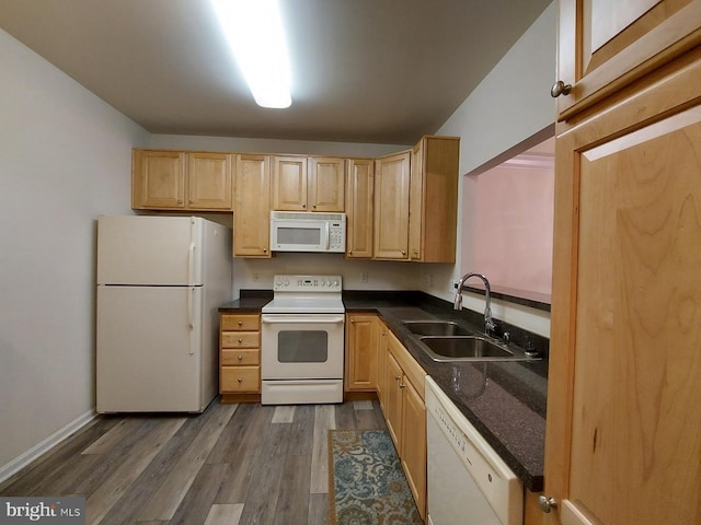 kitchen featuring light brown cabinets, white appliances, dark wood-type flooring, and sink