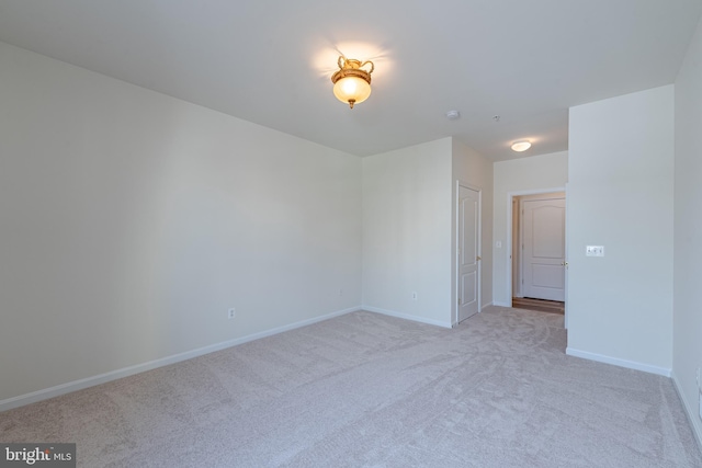 empty room featuring light carpet