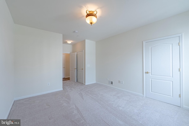 unfurnished room with light colored carpet