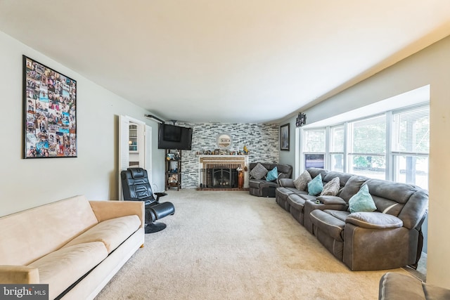 living room featuring a large fireplace and light carpet