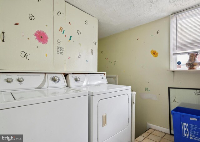 1337 S 54th St, Philadelphia, PA 19143 - clothes washing area featuring light tile patterned floors, washing machine and dryer, laundry area, and a textured ceiling