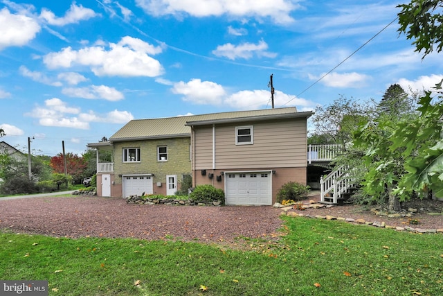 view of front of property featuring a garage and a wooden deck