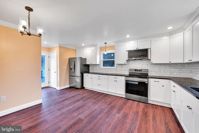 kitchen with white cabinets, dark hardwood / wood-style floors, stainless steel appliances, and hanging light fixtures