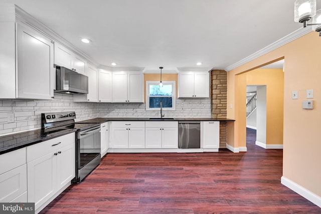 kitchen with white cabinetry, dark hardwood / wood-style floors, stainless steel appliances, and decorative light fixtures