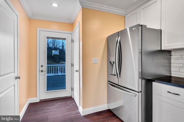 kitchen with white cabinetry, dark hardwood / wood-style flooring, stainless steel fridge with ice dispenser, and backsplash