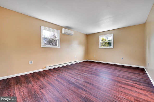 unfurnished room featuring a wall mounted AC, wood-type flooring, and baseboard heating