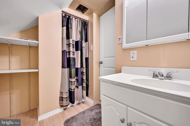 bathroom with vanity and hardwood / wood-style flooring