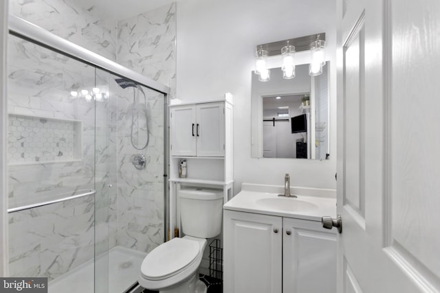 bathroom with vanity, an enclosed shower, and toilet