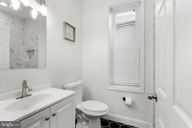 bathroom featuring tile patterned flooring, vanity, and toilet