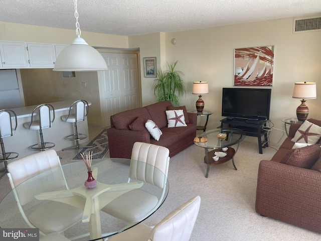 living room with light carpet and a textured ceiling