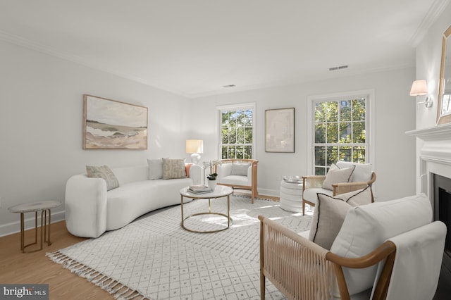 living room with crown molding and hardwood / wood-style flooring