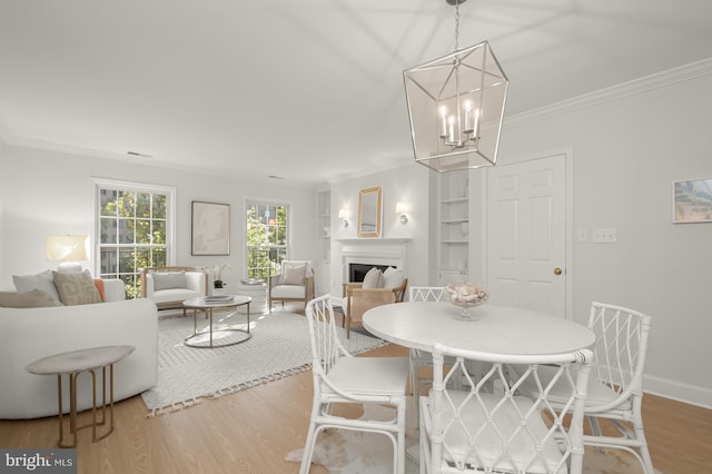 dining room featuring ornamental molding, hardwood / wood-style floors, and a chandelier