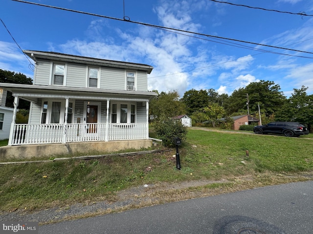 view of front facade with a front yard and a porch