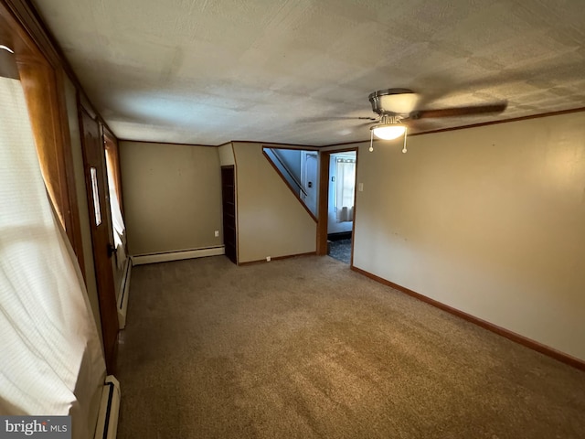 spare room with carpet floors, a textured ceiling, ceiling fan, and a baseboard radiator