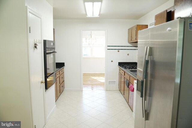 kitchen with appliances with stainless steel finishes and light tile patterned flooring