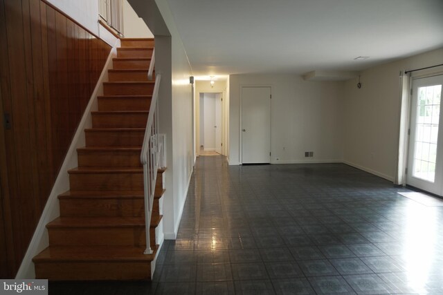 staircase with wood walls