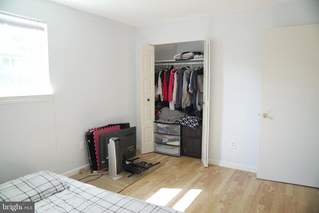 bedroom featuring light wood-type flooring and a closet