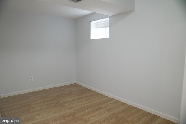 basement with light hardwood / wood-style floors