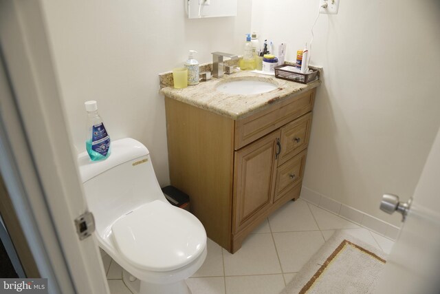 bathroom with vanity, toilet, and tile patterned floors