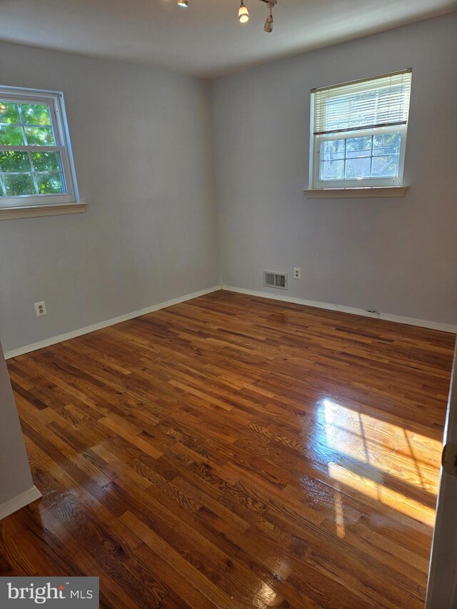 spare room featuring dark hardwood / wood-style flooring