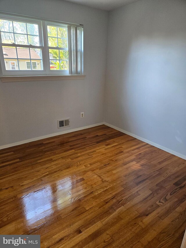 unfurnished room featuring dark hardwood / wood-style floors