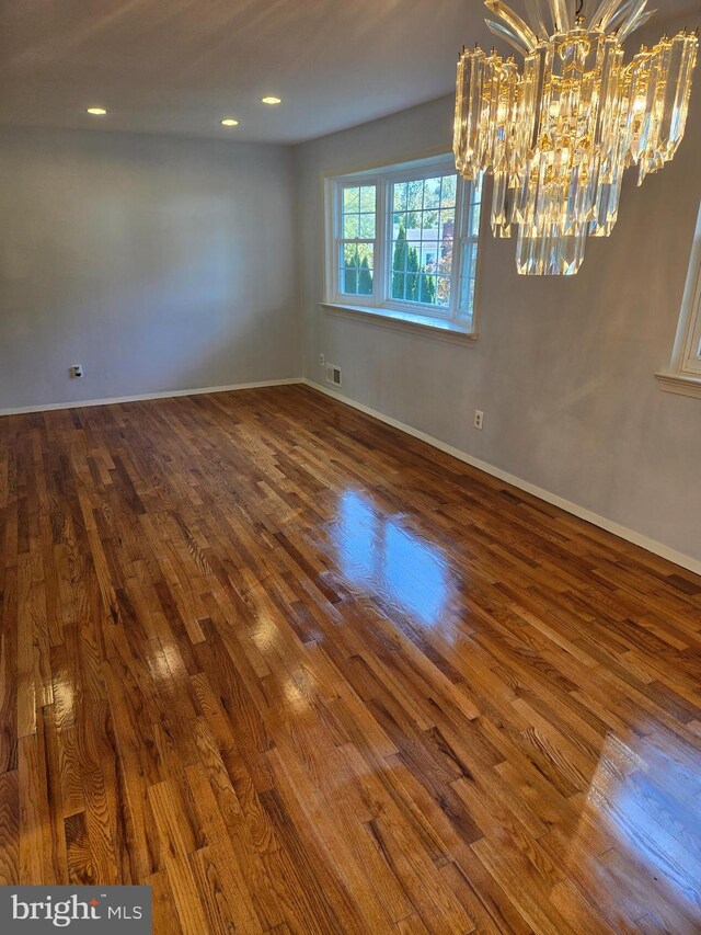 unfurnished room with dark hardwood / wood-style floors