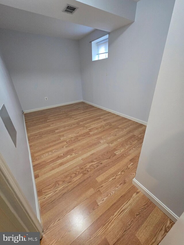 basement with light hardwood / wood-style floors