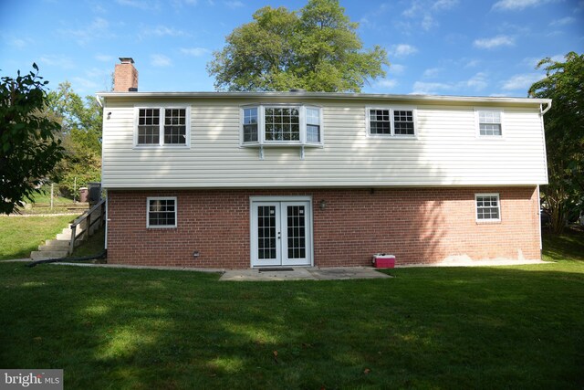 rear view of property featuring a patio area, french doors, and a yard