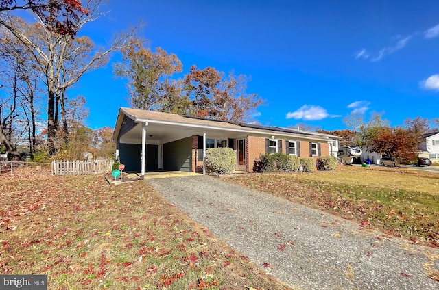 single story home with a front yard and a carport