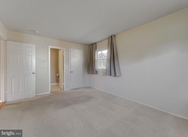 unfurnished bedroom featuring light colored carpet