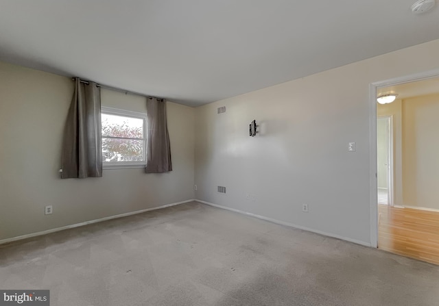 unfurnished room with light carpet