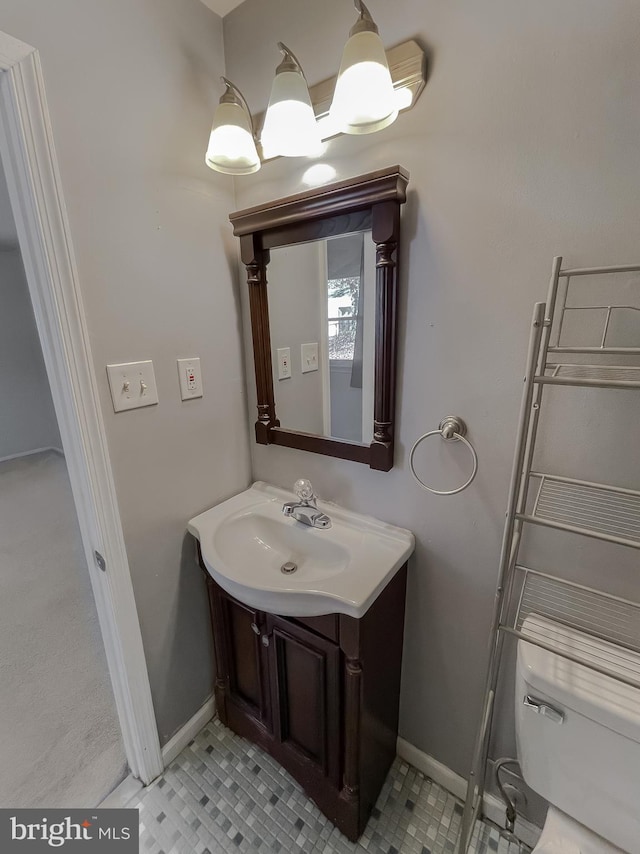 bathroom with tile patterned floors, vanity, and toilet