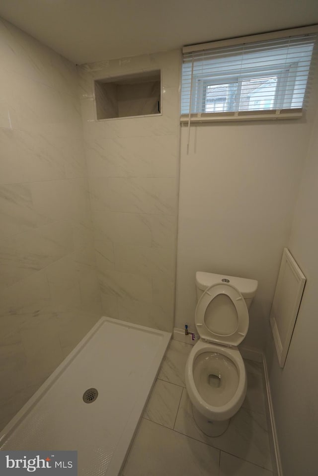 bathroom with a shower and toilet