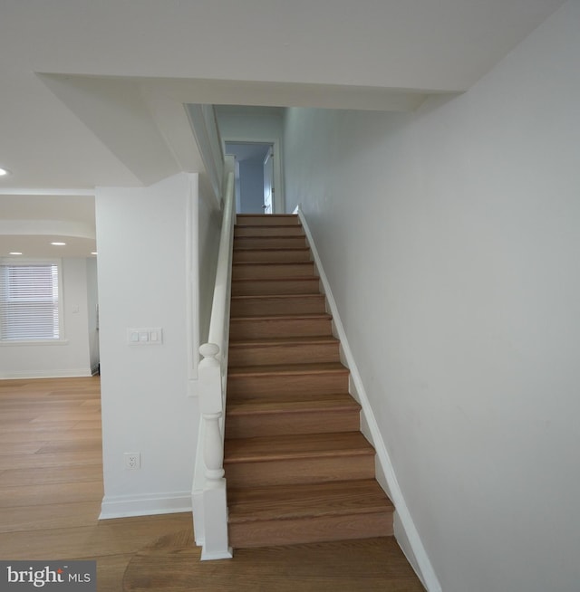 stairs with hardwood / wood-style floors