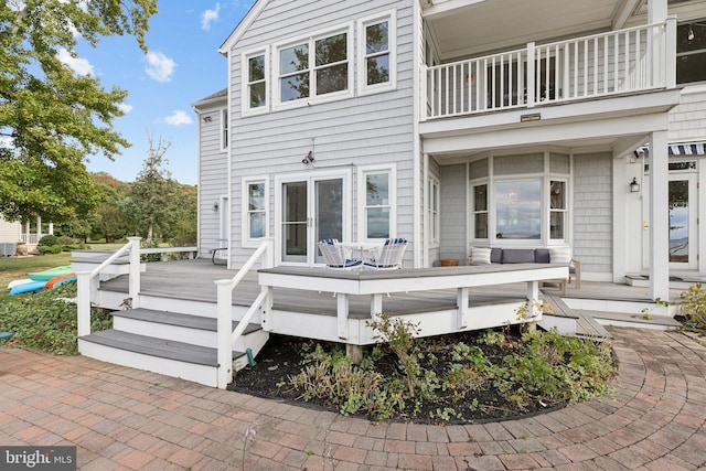 back of property featuring a balcony