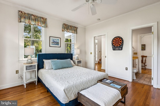 bedroom with ornamental molding, connected bathroom, hardwood / wood-style flooring, and ceiling fan