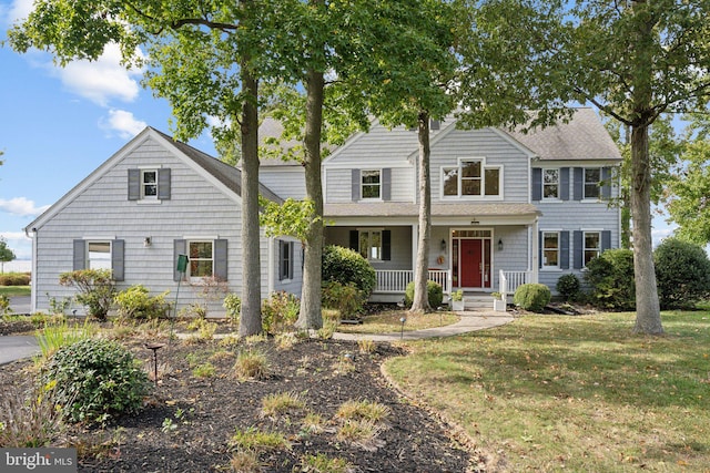 view of front of property with a porch and a front yard