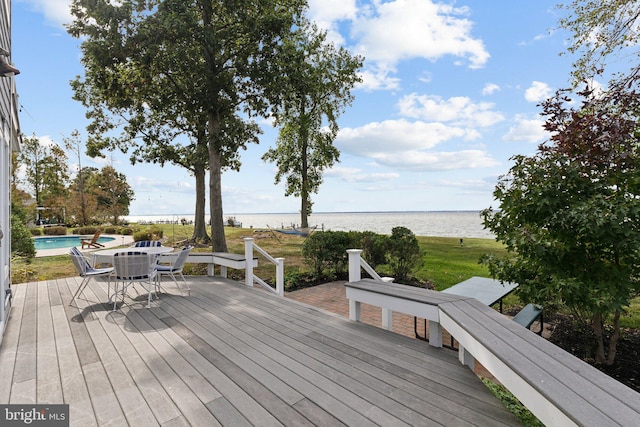 wooden terrace featuring a water view