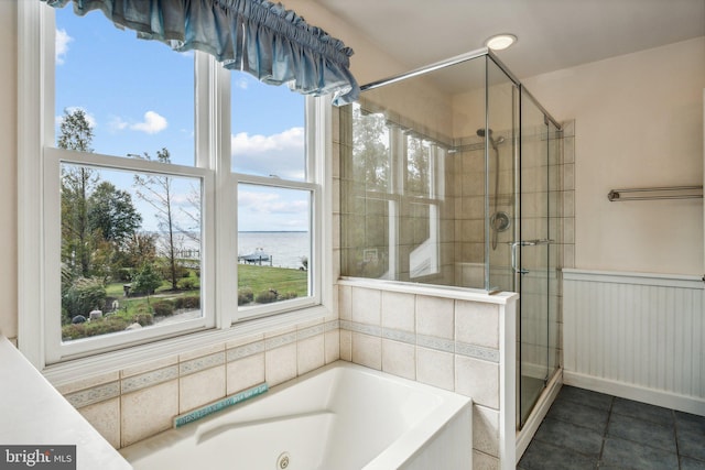 bathroom with a water view, plenty of natural light, separate shower and tub, and tile patterned floors