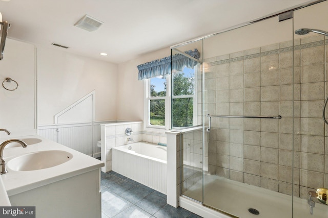 full bathroom with independent shower and bath, vanity, toilet, and tile patterned floors