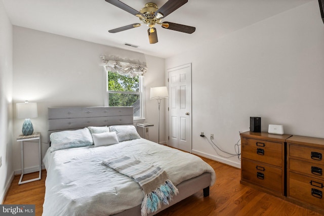 bedroom with hardwood / wood-style floors and ceiling fan