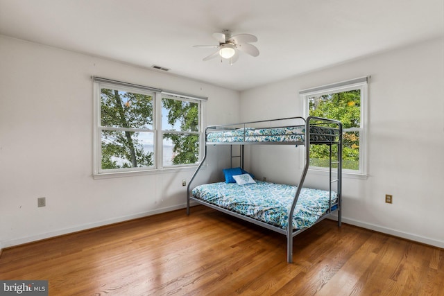 bedroom with wood-type flooring and ceiling fan