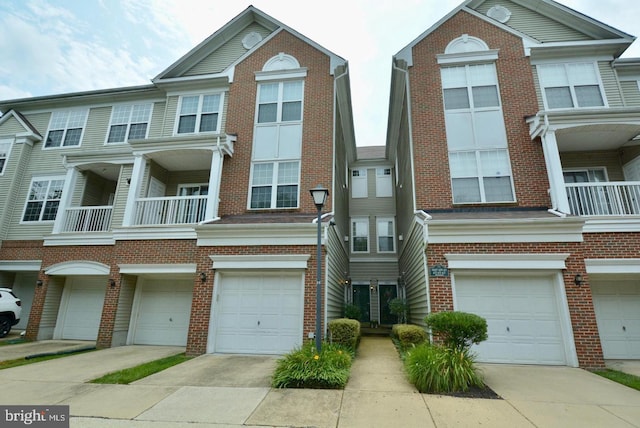 view of property with a balcony and a garage